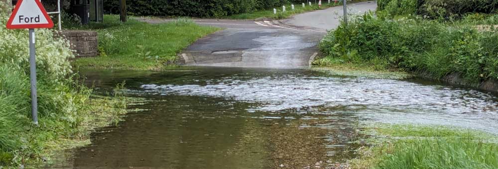 Newton Toney Wiltshire village image showing the Bourne river in flood